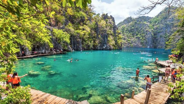 People swimming at Kayangan Lake in Coron Island, Palawan, the Philippines.
