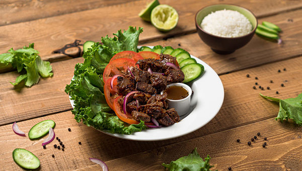 Lok lak, also known as shaking beef, is a beef dish served with lettuce and tomatoes.