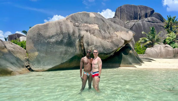 The author and his husband on one of La Digue's beaches in The Seychelles.