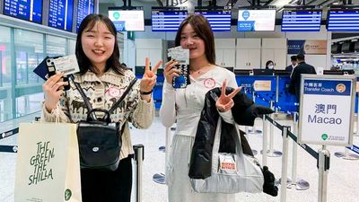 Travellers collect one-way coach ticket upon arrival in Hong Kong International Airport.
