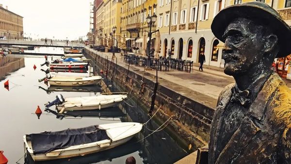 A statue of Irish author James Joyce on the Ponte Rosso bridge crossing the Grand Canal.