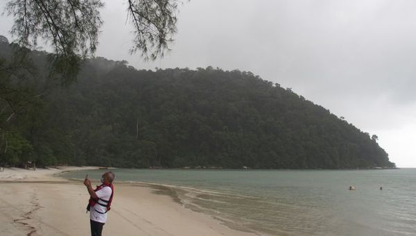 The famous Monkey Beach and its coral sand, while the onslaught of a thunderstorm did not faze the intrepid Hamzah.
