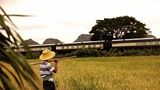 Farmer waving to The Eastern & Oriental Express