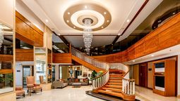 A sweeping staircase and chandelier frame the lobby at Best Western Plus Pulsar Cagayan.