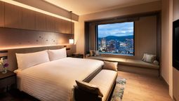 Hilton Hiroshima’s one-bedroom suite offers views of the city with the mountains looming in the distance.