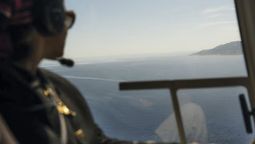 A guest looks out from a helicopter while on a Luxury Collection Expeditions experience.