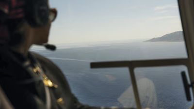 A guest looks out from a helicopter while on a Luxury Collection Expeditions experience.