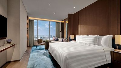 The 158 rooms and suites feature chic aesthetics, avant-garde designs, panoramic city views, and personalized pillow menus for restful sleep.