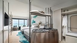 The Premium Deluxe Room offers 38 square metres of space with modern amenities, a sofa, rain shower, and views of the sea or city.