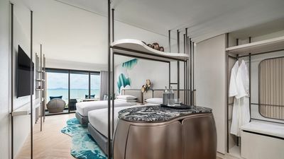 The Premium Deluxe Room offers 38 square metres of space with modern amenities, a sofa, rain shower, and views of the sea or city.