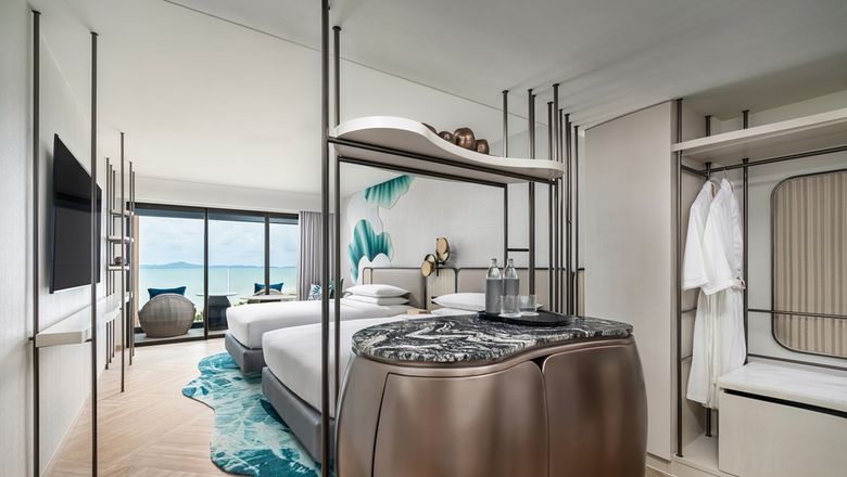 The Premium Deluxe Room offers 38 square metres of space with modern amenities, a sofa, rain shower, and views of the sea or city.