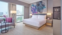 Grand Copthorne Waterfront Hotel's sustainable guestroom features include in-room water filtration, smart thermostats, wireless charging, and high-definition smart TVs.