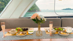 Private sunset yacht dinner in Singapore includes soup, main course, drinks and optional catch-of-the-day.