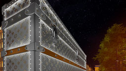 Iconic Louis Vuitton monogrammed trunk facade now adorns Paris building amid luxury hotel renovation rumours.