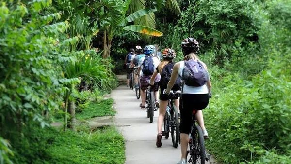 Azerai’s Can Tho Cycling Tour lets visitors explore Mekong Delta’s peaceful villages, small canals, and an organic cocoa farm, all while cycling over "Monkey Bridges" and learning local stories.
