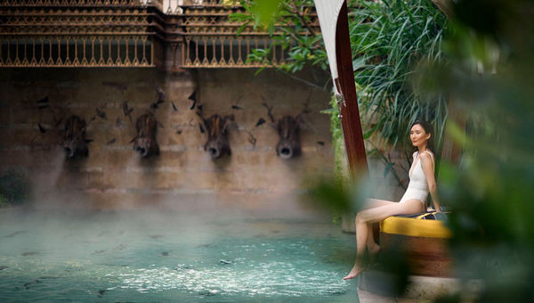 The St Regis Jakarta pool features a bohemian vibe, framed by hot air balloon-styled cabanas and quirky outdoor décor with a playful touch.