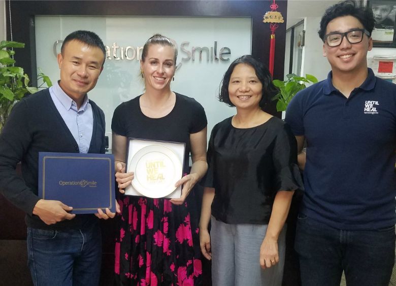 Staff at Operation Smile Vietnam receive funds and mementoes donated by participants in the 2019 YAANA Corporate Challenge.
