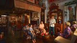 Alvin Yapp (standing) sharing stories with visitors to The Intan.