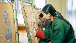 Visitors join a traditional painting session led by senior students at Choki Traditional Arts School, creating their own artwork using time-honoured Bhutanese techniques and motifs.