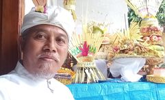 Ida Bagus Sugiharta is a juru terang, a traditional Balinese practitioner known for performing rituals intended to delay rainfall during outdoor events.