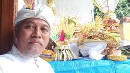 Ida Bagus Sugiharta is a juru terang, a traditional Balinese practitioner known for performing rituals intended to delay rainfall during outdoor events.