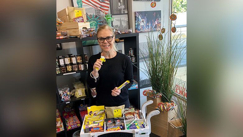 Sue Brownley tests out the sweets at her travel store.