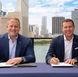 Jason Liberty, chairman and CEO of Royal Caribbean Group, and Adam Stewart, executive chairman of Sandals Resorts, mark the signing of an agreement of the landmark partnership.