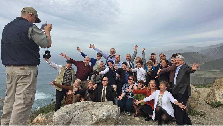 Students of the International Tour Management Institute take a group photo on Highway 1.