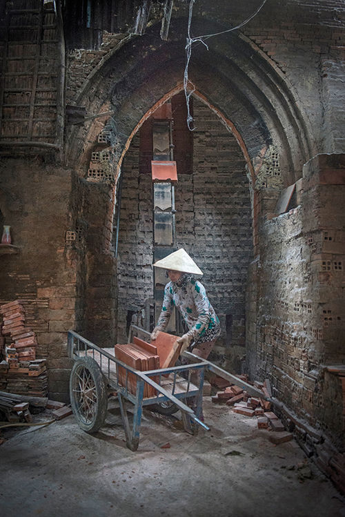 Tiles being loaded onto a cart in a brick factory in Sa Dec, Vietnam.