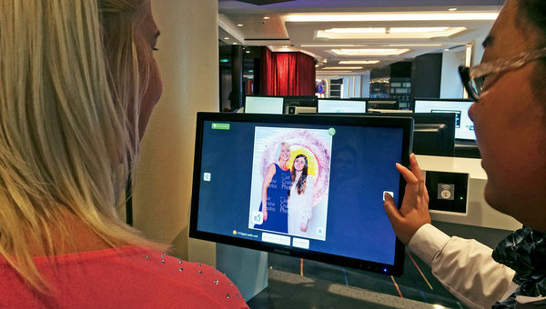 A customer on Royal Caribbean International's Quantum of the Seas chooses photos with the Image Group's Li Jing. A customer on Royal Caribbean International's Quantum of the Seas chooses photos with the Image Group's Li Jing.