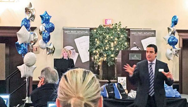 Royal Caribbean’s Juan Silva training agents on the Espresso booking engine in Davie, Fla.