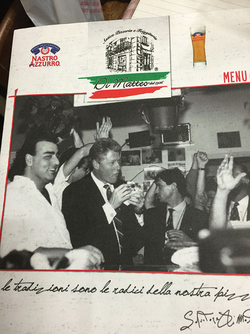 Di Matteo’s menu features a picture of President Clinton munching a slice during his visit in 1994. Di Matteo’s menu features a picture of President Clinton munching a slice during his visit in 1994.