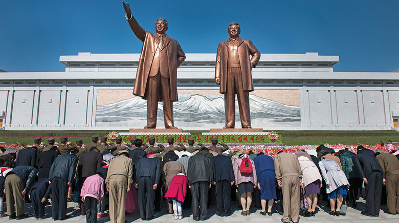 It's been over 60 years since the signing of the Korean Armistice Agreement, but recent events illustrate that North and South Korea are not any closer to a true or lasting peace. Still, there are those on both sides of the DMZ who are trying to bring about a detente. Their weapon of choice: tourism. Upon returning recently from North Korea, award-winning photographer and travel writer Mark Edward Harris filed these exclusive images. Pictured here, North Koreans bow to the newly unveiled statues of Kim Il Sung and Kim Jong Il in Pyongyang at the Mansudae Grand Monument.