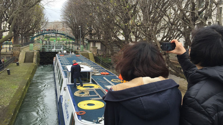 CroisiEurope’s Raymonde attracts an audience as it passes through locks on  Canal Saint-Martin.