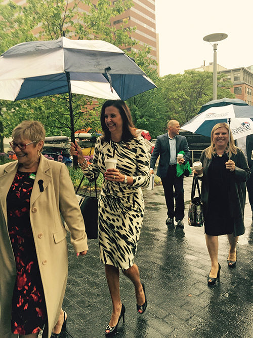 Celebrity Cruises Senior Vice President Dondra Ritzenthaler, in black-and-white dress, and Celebrity Cruises CEO Lisa Lutoff-Perlo, in black dress, arrive in rainy Boston to meet with representatives of World Travel Holdings.