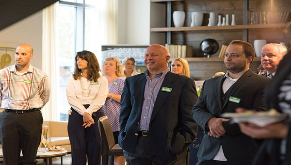 From left, Chuck Nardozza, Director of Regional Sales, AAA Northeast; Joanne Monahan, Director of Branch Sales and Product, AAA Northeast; Bill King, owner, Cruise Holidays of Lakeville; and Joe Giampietro, president of Cruise Brothers, East Providence, R.I., and others listen to Celebrity Cruises CEO Lisa Lutoff-Perlo speak at the indoor lawn party in Cambridge, Mass.