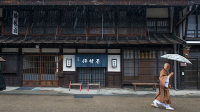 A monk makes his way through the rain in the town of Narai on the historic Nakasendo.