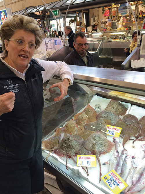 Kathryn Kelly, Oceania Cruises’ director of culinary enrichment, gives shopping tips at Central Market in Livorno. Kathryn Kelly, Oceania Cruises’ director of culinary enrichment, gives shopping tips at Central Market in Livorno.