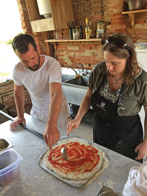 Chef David Gastaldin helps a visitor prepare a pizza at the Torre a Cenaia Estate in Italy’s Tuscany region. Chef David Gastaldin helps a visitor prepare a pizza at the Torre a Cenaia Estate in Italy’s Tuscany region.