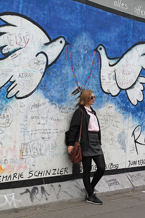 Along the Spree River, a woman poses at the East Side Gallery, the longest remaining section of the Berlin Wall. Along the Spree River, a woman poses at the East Side Gallery, the longest remaining section of the Berlin Wall.
