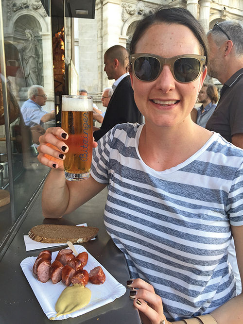 The writer stops at a popular sausage stand in Vienna during a culinary tour of the town.