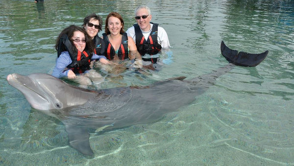 Rebekah Lovitt, left, whom Make-a-Wish flew free to Hawaii with the help of Alaska Air's Charity Miles program, swam with the dolphins at the Hilton Waikoloa Village on the Big Island. Rebekah Lovitt, left, whom Make-a-Wish flew free to Hawaii with the help of Alaska Air's Charity Miles program, swam with the dolphins at the Hilton Waikoloa Village on the Big Island.
