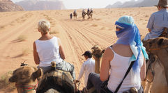 When travelers think of Jordan, they usually conjure up images of the ancient city of Petra. And Petra is, without a doubt, an awe-inspiring sight to behold. But Jordan is also so much more than Petra. Pictured here, an Intrepid Travel tour group rides camels into Jordan's Bedouin desert region, Wadi Rum.