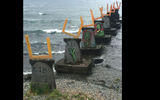 It was unclear whether the artist or a graffiti artist first recognized these shapes as tombstones in this Puerto Varas lakefront sculpture.