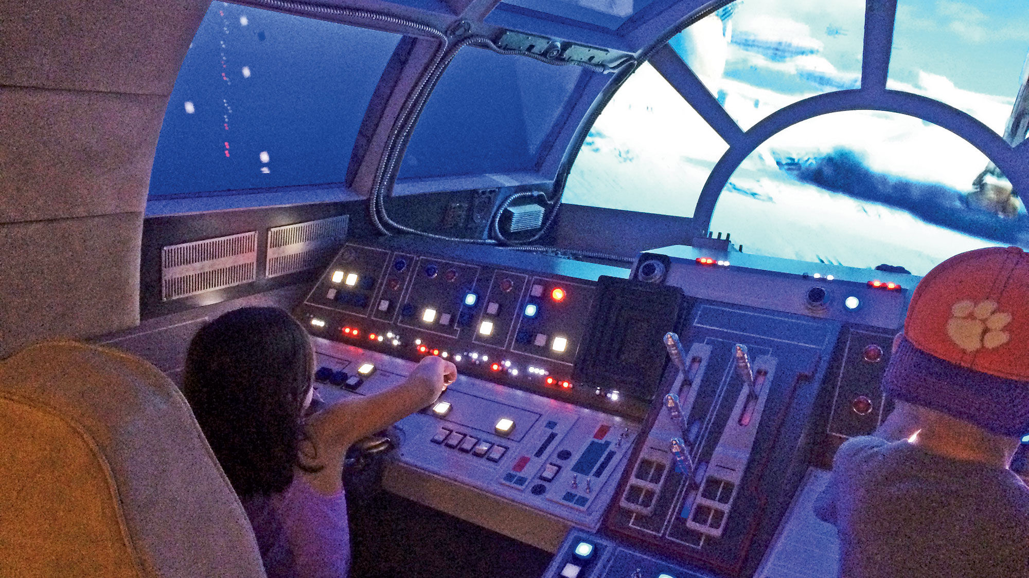 A Millennium Falcon simulator lets guests “fly” over Star Wars landscapes.