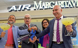 Javier Gavilian, left, formerly of IMC, an airport restaurant operator; Miami-Dade Aviation Director Emilio Gonzalez; Air Margaritaville's Paula Irizzary; and IMC CEO Jaime Szulc celebrate the opening of the Air Margaritaville restaurant at Miami Airport.