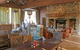 The interior of the hall, which has a fireplace and comfy chairs, helps separate glamping from camping.