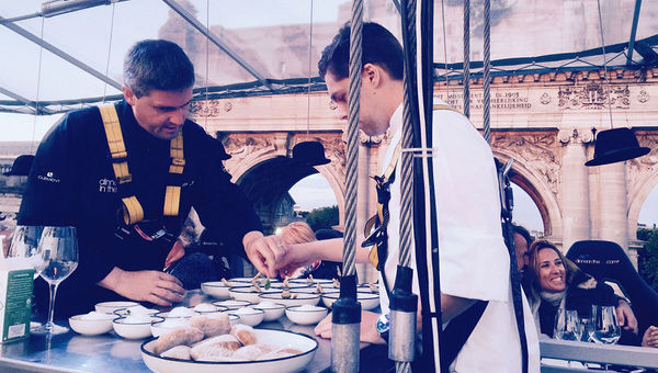 Dinner in the Sky in Brussels hoists diners 150 feet in the air via crane for a meal served by Michelin-starred chefs. Dinner in the Sky in Brussels hoists diners 150 feet in the air via crane for a meal served by Michelin-starred chefs.