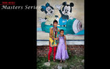 Sisters in front of a wall with Disney characters.