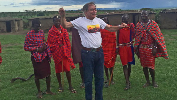 The author shows off his jumping ability to warriors in a Maasai village.